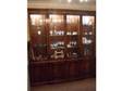Dark wood wall unit. Reproduction antique glass front....